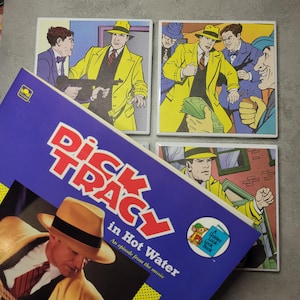 May include: A set of four square ceramic coasters featuring comic book panels of Dick Tracy in a yellow coat and fedora. A book titled "Dick Tracy in Hot Water" is in the foreground, with a blue cover and the Golden Look-Look Book logo.