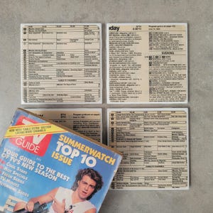May include: A vintage TV Guide magazine with a Summerwatch Top 10 issue cover featuring a man with brown hair. The magazine is open to a page with a listing of TV shows and their times. The magazine is sitting on top of four coasters with a vintage TV guide schedule printed on them.