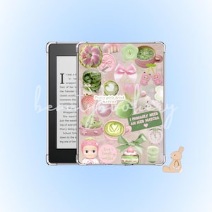 May include: A decorative Kindle case featuring a collage of matcha-themed stickers in shades of pink and green. The stickers depict matcha lattes, bows, strawberries, and the phrases "Pretty girls drink matcha" and "I probably need an iced matcha."