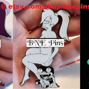 May include: A set of three enamel pins featuring a cartoon character. The first pin is in color, the second is white, and the third glows in the dark. The pins feature a woman sitting on a small creature. The text "BNE Pins" is visible on each pin.