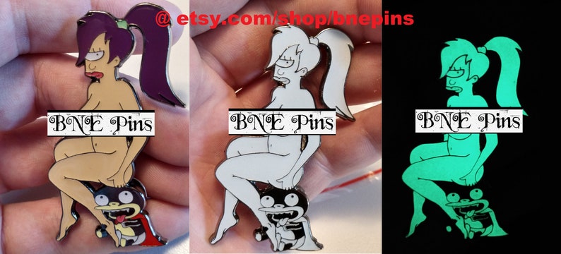 May include: A set of three enamel pins featuring a cartoon character. The first pin is in color, the second is white, and the third glows in the dark. The pins feature a woman sitting on a small creature. The text "BNE Pins" is visible on each pin.