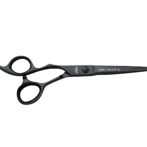 May include: Black hair cutting shears with a curved handle and a black finish. The shears have a silver logo and the text "シザー クオリティー" on the blade.