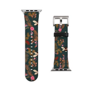 May include: A green Apple Watch band with a floral and bee pattern. The band is made of leather and has a silver buckle.