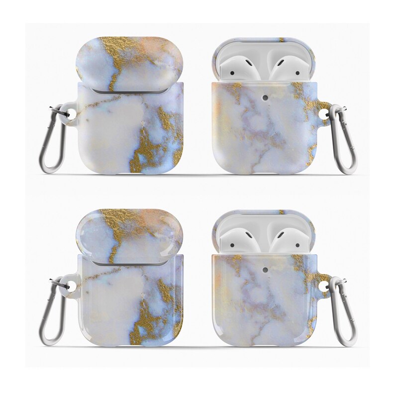 May include: A white and gold marble patterned protective case for AirPods with a carabiner clip. The case is open and closed, showing the inside of the case.