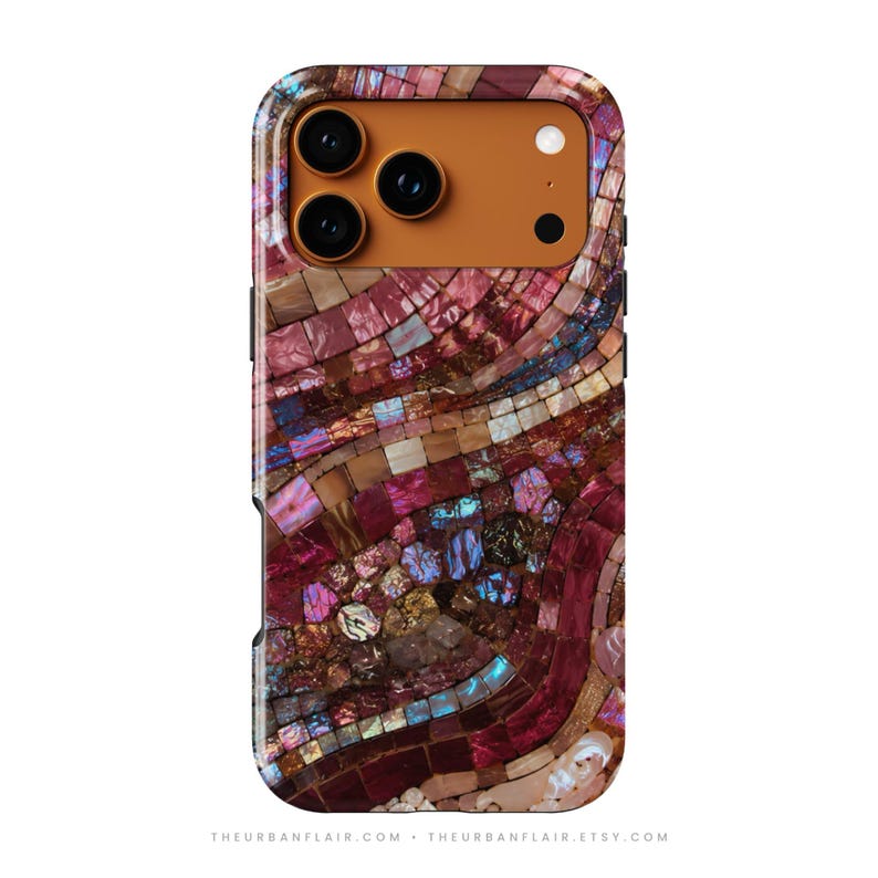May include: A smartphone case featuring a vibrant mosaic pattern of iridescent pink, purple, and blue tiles. The camera module area is a solid, smooth orange color. The design covers the entire back surface of the rectangular phone case.
