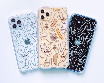 May include: Three clear phone cases with different abstract line art designs. The cases are all for the iPhone 12 Pro Max and feature a variety of colors, including black, white, and beige.