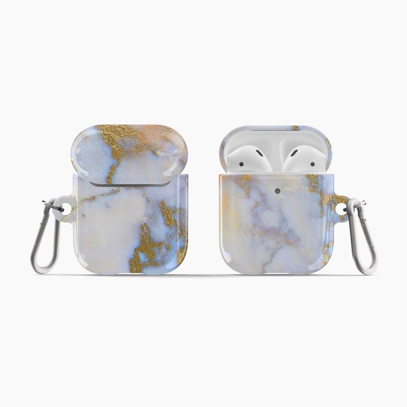 May include: A white and blue marble AirPods case with gold accents and a silver carabiner. The case is open and the AirPods are visible inside.