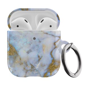 May include: A white and blue marble patterned case for AirPods with a silver metal ring attached. The case is open, revealing the white AirPods inside.
