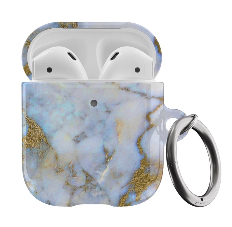 May include: A white and blue marble patterned case for AirPods with a silver metal ring attached. The case is open, revealing the white AirPods inside.