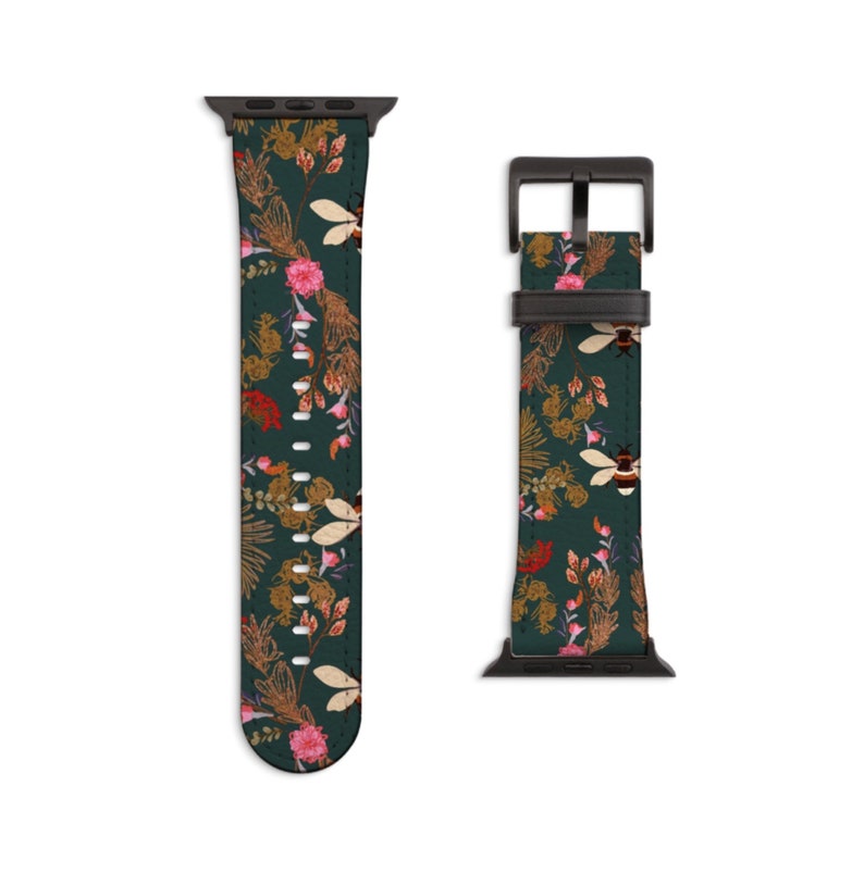 May include: A dark green Apple Watch band featuring a floral and bee design. The band is made of leather and has a black metal buckle.