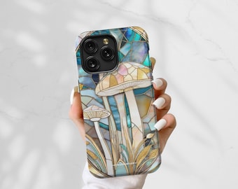 May include: A phone case with a stained glass design featuring mushrooms in shades of blue, green, and gold. The case has a clear back and a black frame.