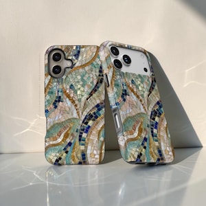 May include: Two phone cases featuring a mosaic pattern of iridescent shell-like tiles in shades of teal, navy blue, gold, and cream. The design consists of curved, flowing lines and small square tiles, creating a textured, reflective appearance.