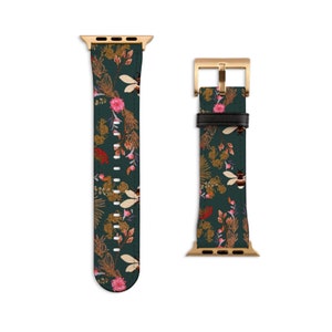 May include: A green leather Apple Watch band with a floral and bee pattern. The band has a gold buckle and a gold adapter.