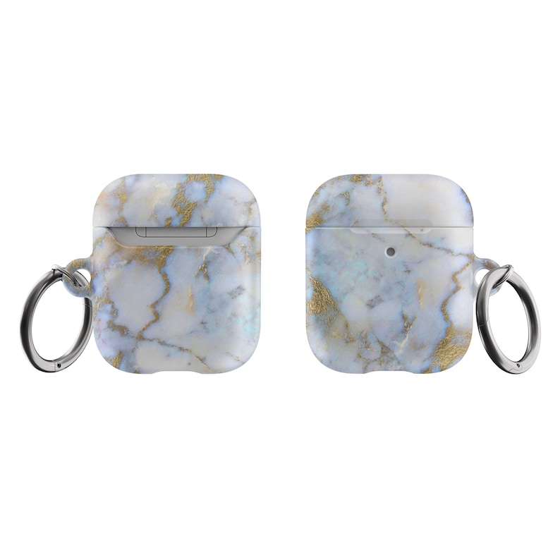 May include: A white and gold marble patterned Airpods case with a silver key ring.