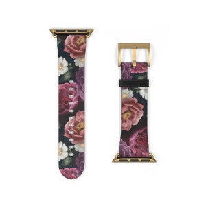 May include: A gold and black floral patterned Apple Watch band with a gold buckle.