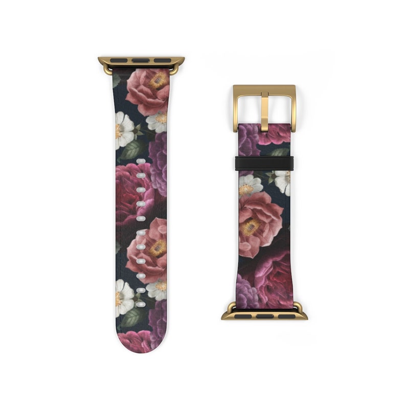 May include: A gold and black floral patterned Apple Watch band with a gold buckle.
