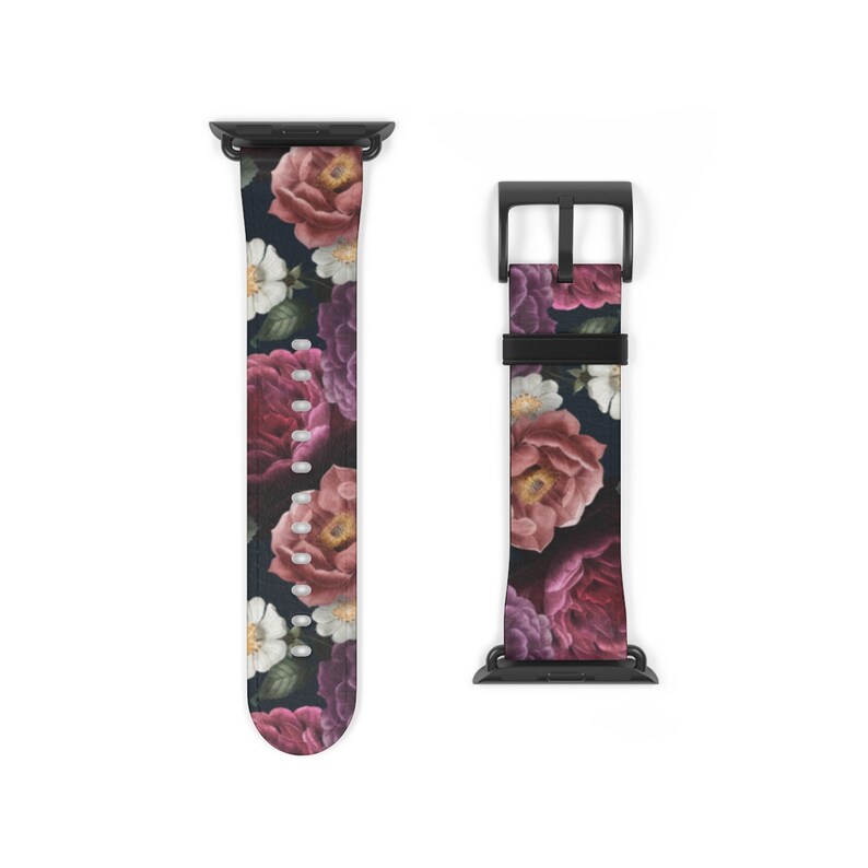 May include: A black Apple Watch band with a floral print featuring pink, purple, and white flowers on a dark background.