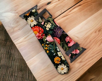 May include: A black Apple Watch band with a floral print featuring pink, red, yellow, and white flowers on a dark green background.