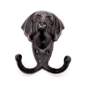 May include: Black cast iron dog head wall hook with two curved hooks. The dog's head features detailed fur texture and facial features. The hook is mounted on a white background.