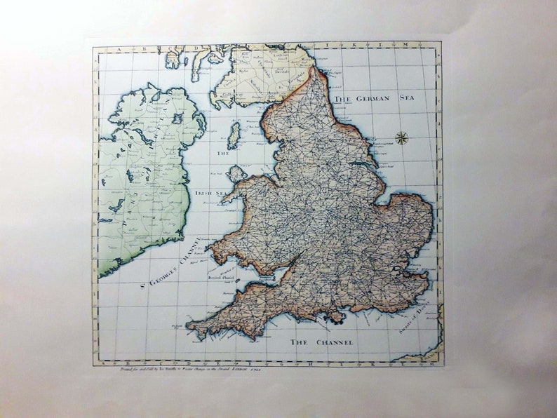 May include: An antique map of England and Ireland, printed in 1769. The map is in shades of brown, green, and blue, with a grid overlay. The map shows the major cities, rivers, and roads of England and Ireland. The text "The German Sea" and "The Channel" are visible on the map.