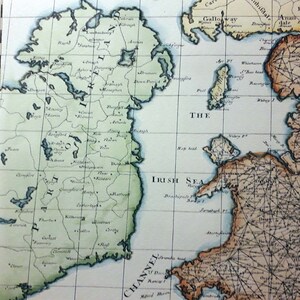 May include: An antique map of Ireland with a green outline of the island and a blue outline of the surrounding sea. The map includes the text "PART of IRELAND" and "THE IRISH SEA".