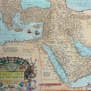 May include: An antique map of the Ottoman Empire, with a decorative border and the text "TVRCICI IMPE RII DESCRIPTIO". The map shows the Mediterranean Sea, the Black Sea, and the Persian Gulf. The map is in shades of blue, brown, and green.