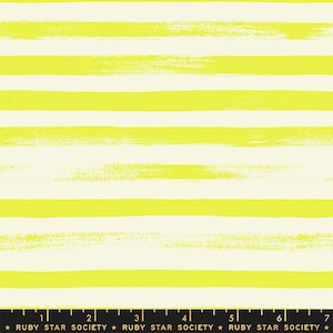 May include: A fabric with a repeating pattern of horizontal, bright yellow brushstrokes on a cream background. The brushstrokes vary in width and texture, creating a hand-painted look. The bottom of the image includes a ruler and the text "RUBY STAR SOCIETY".