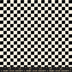 May include: A fabric swatch featuring a repeating black and white checkered pattern with hand-drawn style squares. A black ruler with white markings and the text Ruby Star Society is visible at the bottom, measuring up to 7 inches.