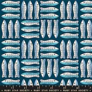 May include: A dark teal fabric featuring a repeating pattern of stylized fish in light blue and cream. The fish are arranged in alternating horizontal and vertical rows. A black ruler at the bottom shows 6 inches with the text Ruby Star Society.