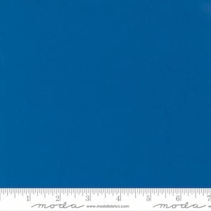 May include: Solid blue fabric swatch with the text "moda" and "www.modafabrics.com" printed on the bottom edge.