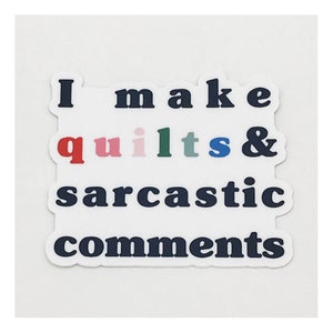 May include: A white sticker with black text that reads "I make quilts & sarcastic comments". The word "quilts" is spelled out in different colors.
