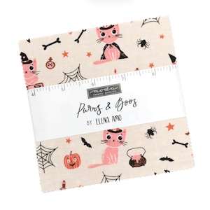 May include: A stack of fabric squares with a Halloween theme. The fabric features pink cats in witch hats and capes, pumpkins, spiderwebs, and stars on a cream background. The text "Purrs & Booz" is printed on a white label.