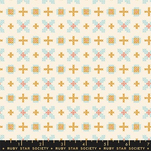 May include: A white fabric with a repeating pattern of small blue, red, and gold cross-stitch designs. The fabric has a subtle texture and a slightly off-white background. The text "RUBY STAR SOCIETY" is printed at the bottom of the fabric.