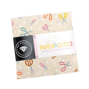 May include: A stack of 42 fabric squares, 5 inches each, with a cream background and colorful scissors and triangle patterns. The label reads "PAPER CUTS 2" by Rashida Coleman Hale, from Ruby Star Society.