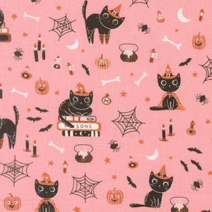 May include: A pink fabric featuring a repeating pattern of black cats wearing orange witch hats, orange pumpkins, white bones, black spiderwebs, spiders, bats, crescent moons, candles, potion bottles, and black cauldrons with orange liquid.