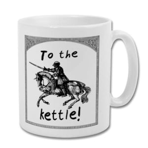 May include: White ceramic mug with a black and white illustration of a knight on horseback, with the text "To the kettle!". The mug has a curved handle and a glossy finish. The design is framed by a decorative border.