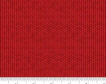 May include: Close-up of a red knitted fabric with a textured pattern. The fabric is displayed against a white background with a ruler at the bottom, showing measurements in inches. The fabric has a repeating vertical pattern.