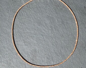 May include: A gold-toned chain necklace with a twisted rope design.