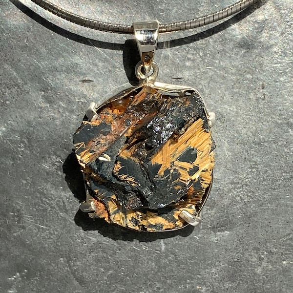 Raw rutile quartz with hematite pendant