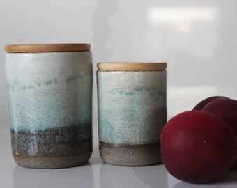 Two ceramic canister sets with wood lid