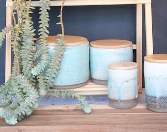 Two ceramic canister sets with wood lid