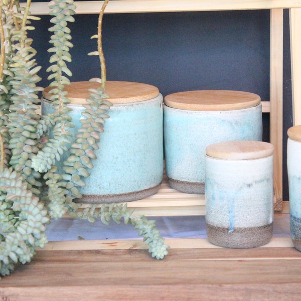 Two ceramic canister sets with wood lid