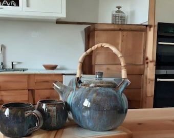 Ceramic turquoise teapot with two cups