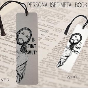 May include: Personalized metal bookmark with a black tassel. The bookmark features a black and white illustration of a religious figure with the text "IS THAT SMUT?" available in silver and white.