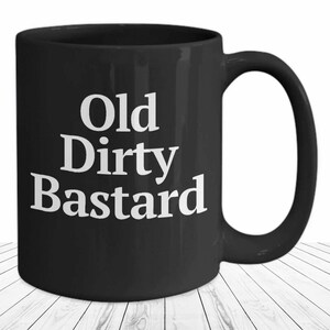 May include: Black coffee mug with white text that reads "Old Dirty Bastard".
