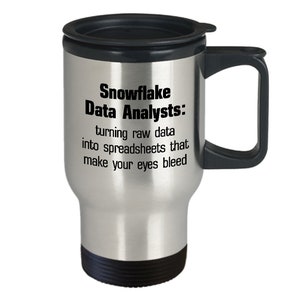 May include: A stainless steel travel mug with a black lid and handle. The mug has a white background with black text that reads "Snowflake Data Analysts: turning raw data into spreadsheets that make your eyes bleed."