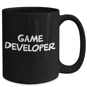 May include: Black ceramic coffee mug with white text that reads "GAME DEVELOPER".