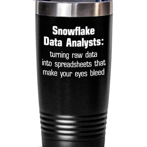 May include: Black stainless steel tumbler with a white inscription that reads "Snowflake Data Analysts: turning raw data into spreadsheets that make your eyes bleed."