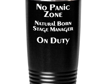 May include: Black stainless steel tumbler with white text that reads "No Panic Zone Natural Born Stage Manager On Duty".