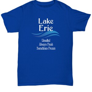 May include: A royal blue t-shirt with white text that reads "Lake Erie Unsalted Always Fresh Sometimes Frozen" with a blue wave design.